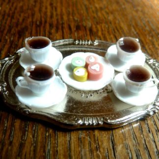 Tablett mit Kaffeetassen und Petit Fours.